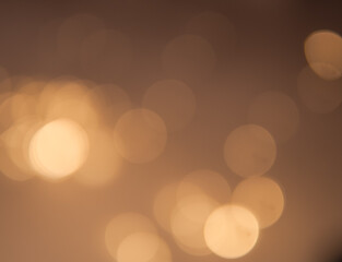 Golden and dark brown round bokeh lights festive background