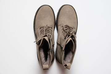 Gray women's winter boots with laces on a white background. The concept of modern women's fashion