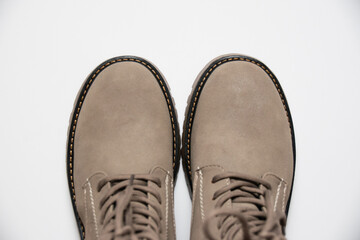Gray women's winter boots with laces on a white background. The concept of modern women's fashion