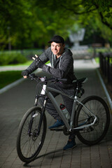 A man in sportswear on a bicycle on a city alley