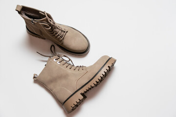 Gray women's winter boots with laces on a white background. The concept of modern women's fashion