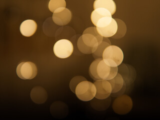 Golden and dark brown round bokeh lights festive background