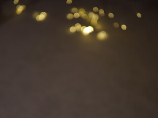 Golden and dark brown round bokeh lights festive background