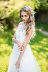 Fototapeta na wymiar woman bride in white wedding dress touching her hand