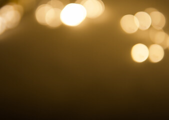 Golden and dark brown round bokeh lights festive background