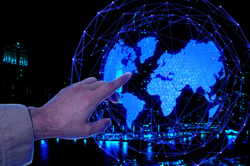 Fototapeta na wymiar Man pointing at digital model of Earth on dark background, closeup