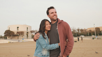 Couple in love spending time together standing on the beach