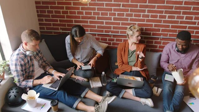 Food, laptop and working student or friends project planning, university startup ideas and studying with coffee cup. Digital, software and graphic design team in college lounge room eating fast food