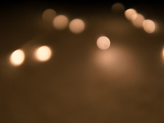 Golden and dark brown round bokeh lights festive background