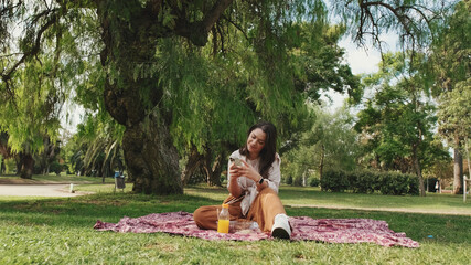 Young woman using phone in the park