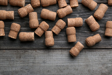 Sparkling wine bottle corks on wooden table, flat lay