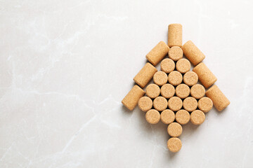 Christmas tree made of wine corks on beige table, top view. Space for text