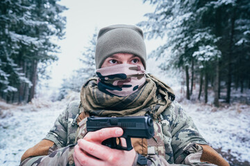 Fototapeta na wymiar Soldier in uniform aims a personal weapon