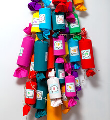 Handmade Advent calendar on wall. The Advent calendar in the shape of Christmas tree is made of homemade large candies with surprise gifts. Creative Alternative Christmas tree, close-up