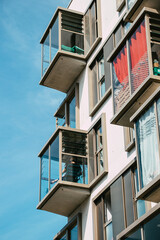 Fototapeta na wymiar Young man listening to music on an original balcony of a modern and innovative new building in Nantes, France
