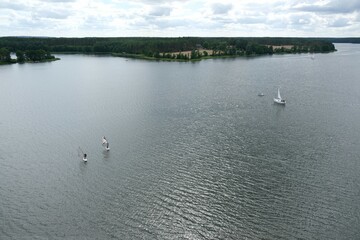 Panorama of lakes with sailing boats and windsurfing boards in Wdzydze Landscape Park from the viewing platform in Wdzydze Kiszewskie, Kaszyby, Poland