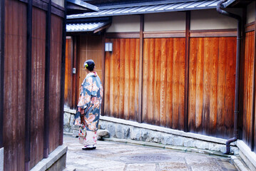 Fototapeta na wymiar Wooden panels of a traditional Japanese house in Kyoto, creating a regular vertical pattern