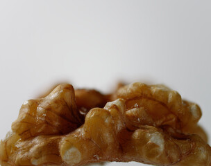 Macro photo of a fresh shelled walnut on a white background