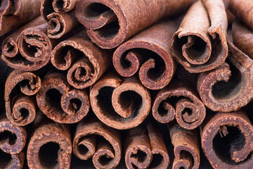texture of brown cinnamon sticks in a pile