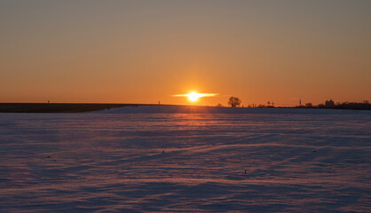 winter landscape and sunset against the background of snow