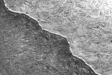 Crack on the ice surface of a frozen reservoir, river or lake,.