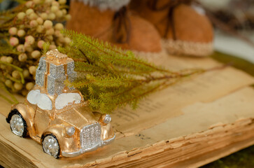 christmas decoration, toy car with a gift, old book
