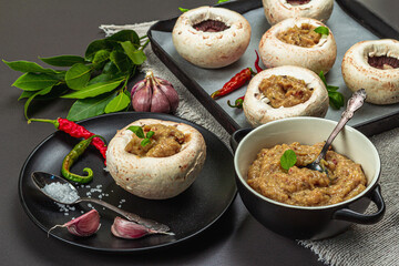 Raw stuffed mushroom caps ready for baking. Fresh champignons, spices, vegetables. Cooking process