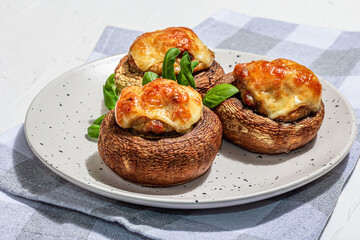Baked stuffed mushroom caps ready for eating. Champignons, spices, vegetables, cheese