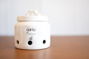 Cute garlic jar on white background with shallow depth of field.