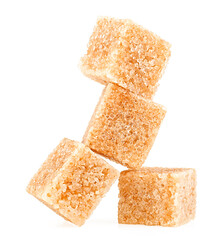Brown cane sugar cubes isolated on a white background
