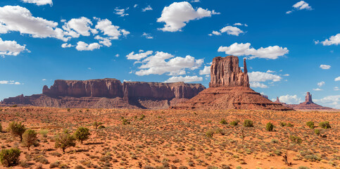Monument Valley iconic rock formations under cloudy blue sky. Navajo Tribal Park , Arizona - Utah,...