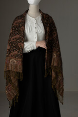 A mannequin with human hands wearing a Victorian blouse and skirt