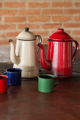 Coffee pot and cups enamelled in the wood stove on rural region of Brazil