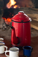 Coffee pot and cups enamelled in the wood stove on rural region of Brazil