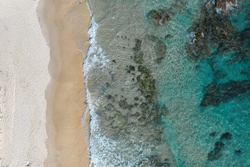 Stunning aerial view of a beach with pristine blue water