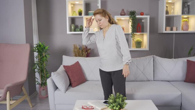 Feeling bad, the old woman faints and collapses to the ground.
The dizzy woman becomes ill and faints.
