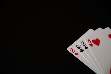 Obraz premium Playing cards showing new year 2024 on an isolated black background. Copy space.