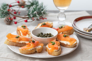 canape with salmon and capers. Christmas food idea. Christmas food. - obrazy, fototapety, plakaty