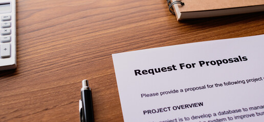 There is dummy documents that created for the photo shoot on the desk about Request For Proposal.
