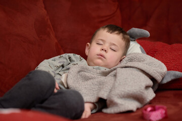 cute toddler sleeping on the couch after a meal