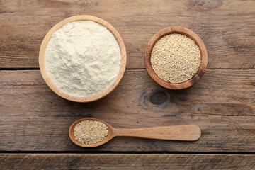 Fototapeta na wymiar Quinoa flour in bowls and spoon with seeds on wooden table, flat lay