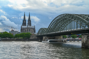Fototapeta premium Cologne, Germany. Buildings in historic city centre. Towers of Cathedral. Famous Hohenzollern Bridge