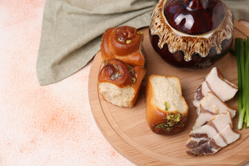 Delicious pampushky (buns with garlic), salo and green onions served for borsch on color textured table, space for text