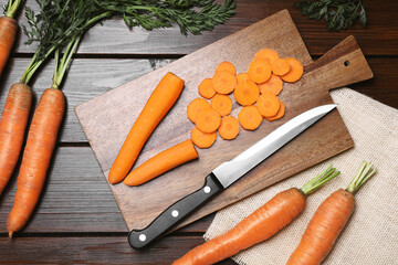 Tasty fresh carrot on wooden table, flat lay
