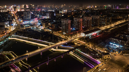 Fototapeta na wymiar Winter night scene along the Yitong River in Changchun, China