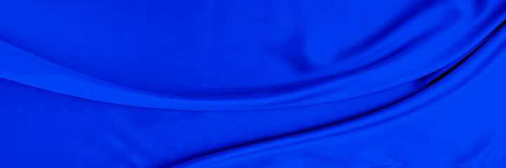 Black blue satin dark fabric texture luxurious shiny that is abstract silk cloth background with patterns soft waves blur beautiful.