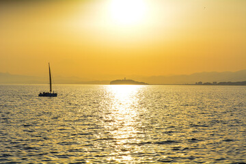 Naklejka na ściany i meble Sunset over the sea and yacht on summer, Shonan, Kanagawa, Japan