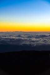 sunset in the mountains over clouds view mauna kea