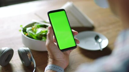 Businessman, hands or green screen phone in coffee shop, restaurant or cafe on social media app or calendar management. Zoom, worker employee or mobile technology mockup of office logo on lunch break - Powered by Adobe