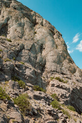High stone rock. The mountain and the turquoise sky.